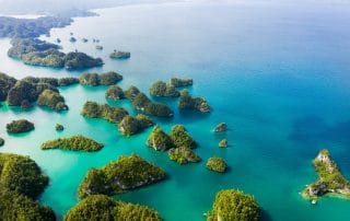 Aerial view of green islands and turquoise sea in Indonesia