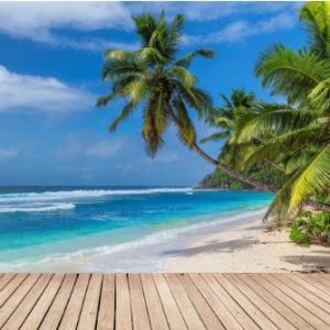 beach-wooden-table-and-coconut-palms-with-party-on-tropical-beach-picture-id1300077585